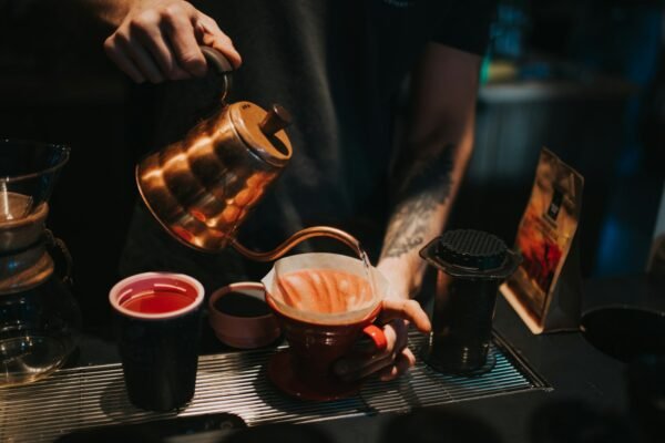Pouring morning coffee into a ceramic mug, a mindful daily ritual