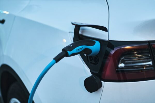 Electric vehicle plugged into a charging station