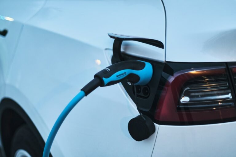 Electric vehicle plugged into a charging station