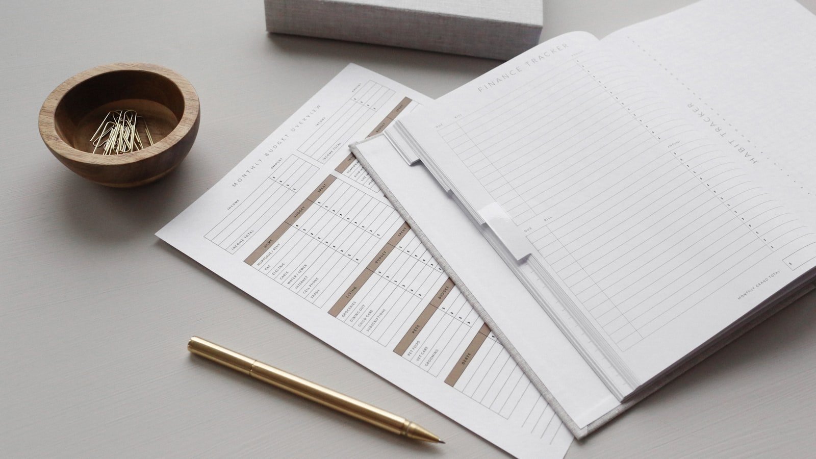 Budget planner with sheets and a gold pen
