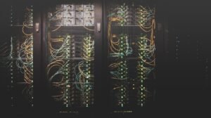 Server racks and network cables in a data center, representing tech's carbon footprint