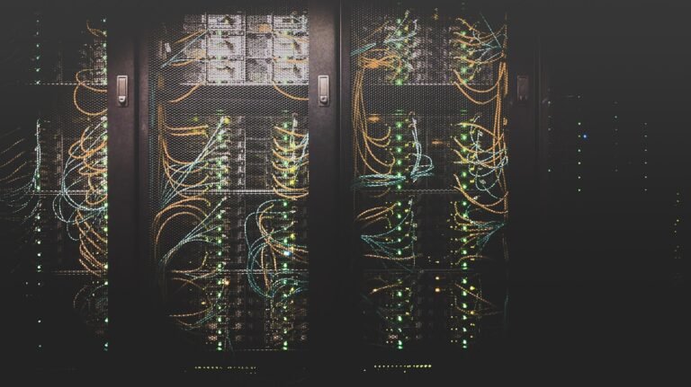 Server racks and network cables in a data center, representing tech's carbon footprint