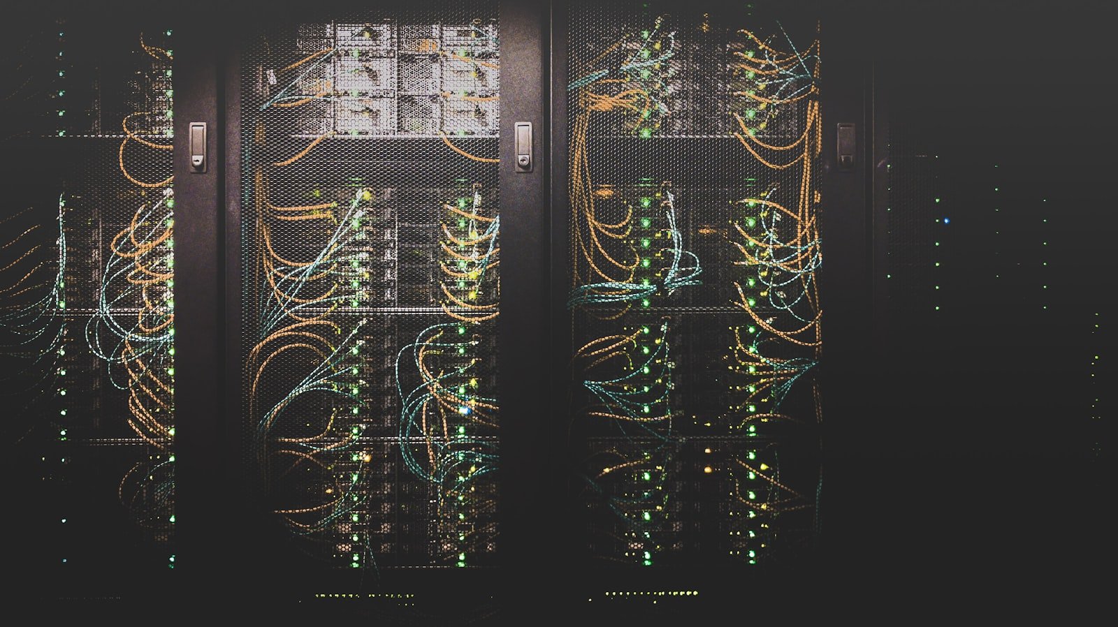 Server racks and network cables in a data center, representing tech's carbon footprint